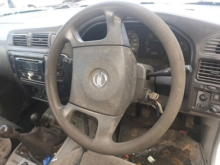 A Dirty Steering Wheel is Sitting on the Dashboard of a Car — South West 4WD Wreckers in Harristown, QLD