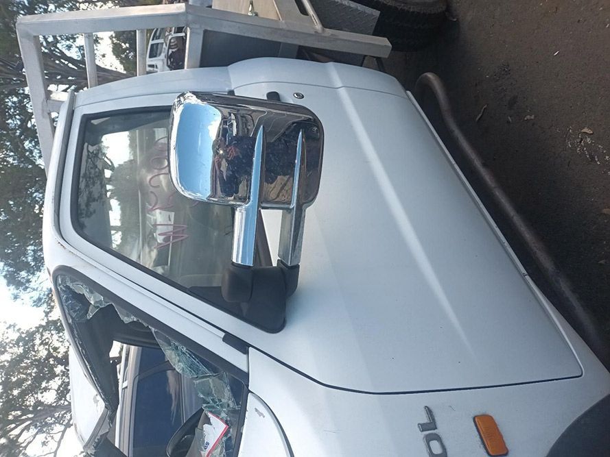 A White Truck with a Broken Windshield is Parked on the Side of the Road — South West 4WD Wreckers in Harristown, QLD