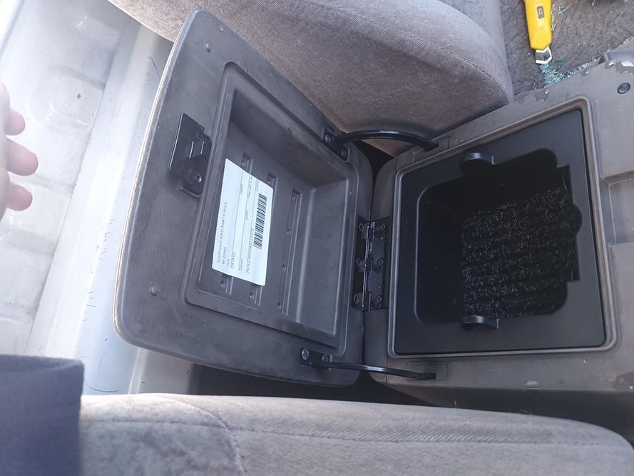 A Person is Standing Next to a Car Console with the Lid Open — South West 4WD Wreckers in Harristown, QLD