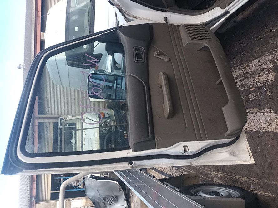 A White Truck with the Door Open is Parked in a Parking Lot — South West 4WD Wreckers in Harristown, QLD