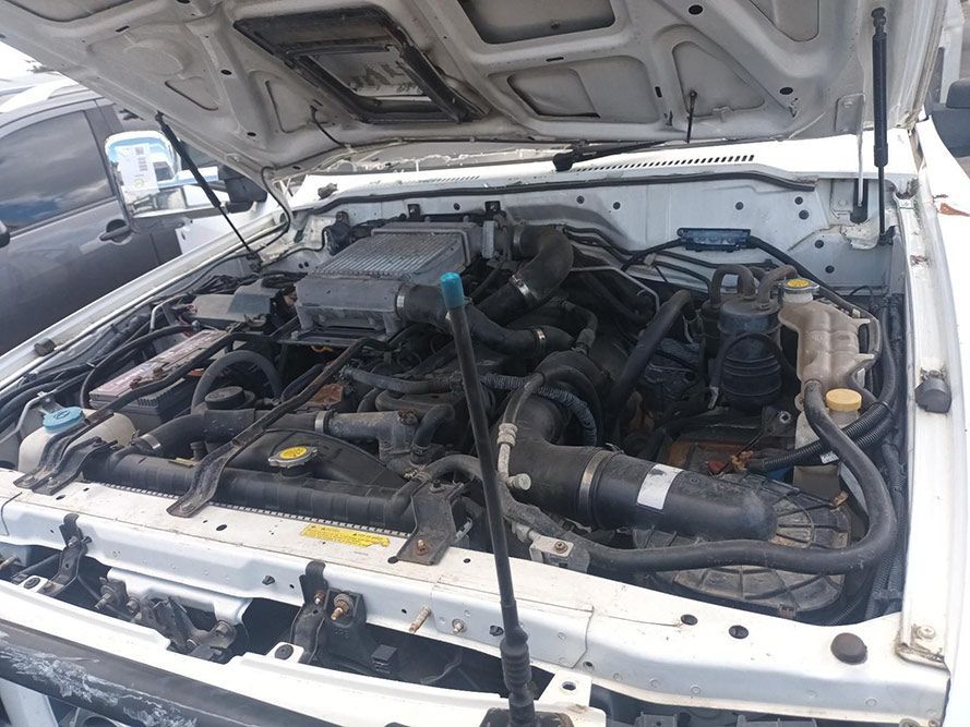 The Engine of a White Car is Shown with the Hood Open — South West 4WD Wreckers in Harristown, QLD