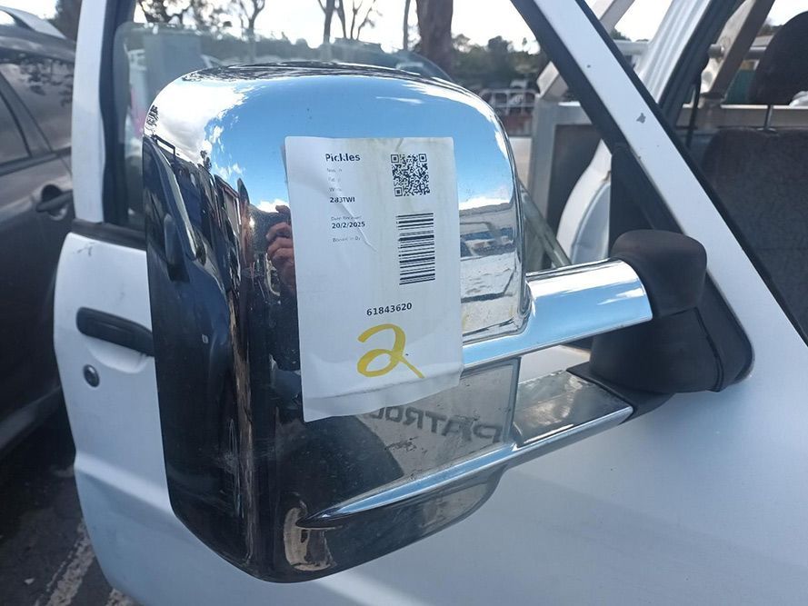 A White Car with a Chrome Side Mirror and a Tag on It — South West 4WD Wreckers in Harristown, QLD