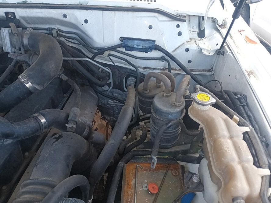 A Close Up of the Engine of a White Car with the Hood Up — South West 4WD Wreckers in Harristown, QLD