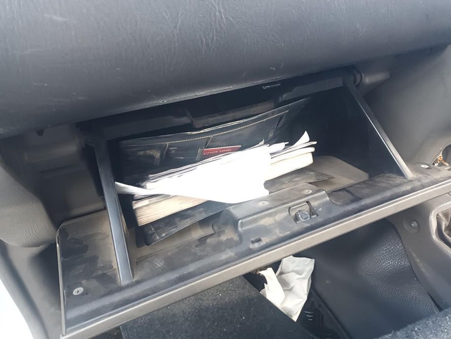 A Glove Box in a Car with a Piece of Paper in It — South West 4WD Wreckers in Harristown, QLD