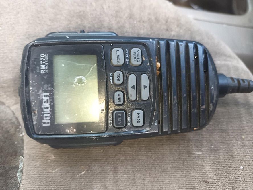 A Uniden Walkie Talkie is Sitting on a Person 's Lap — South West 4WD Wreckers in Harristown, QLD