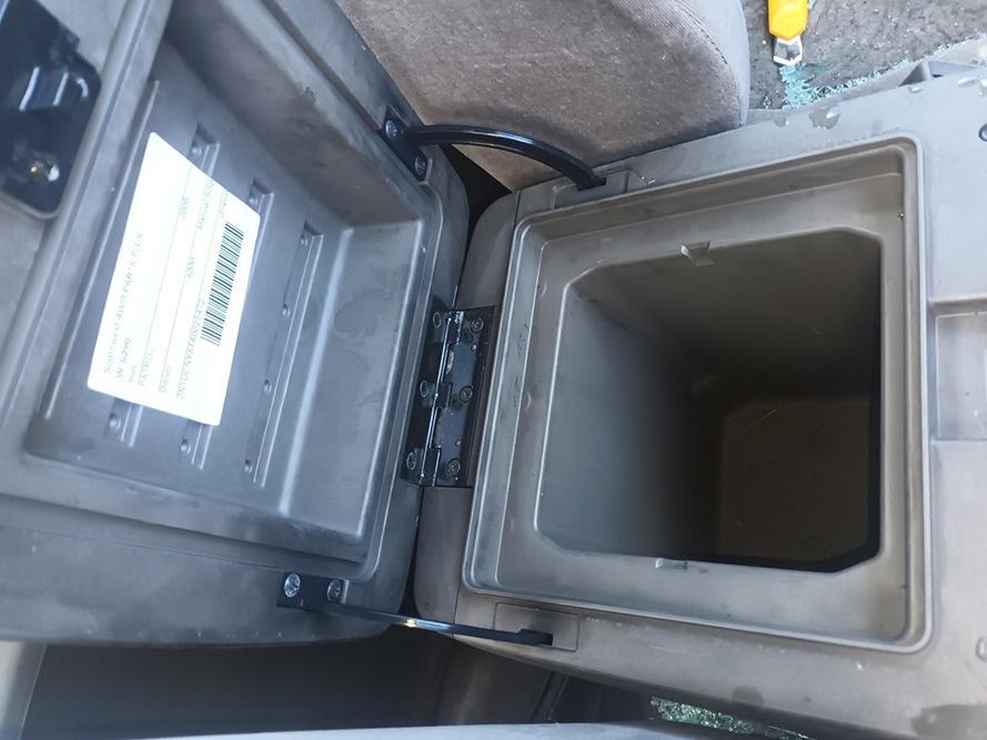 A Car Console with the Lid Open and a Box Inside — South West 4WD Wreckers in Harristown, QLD