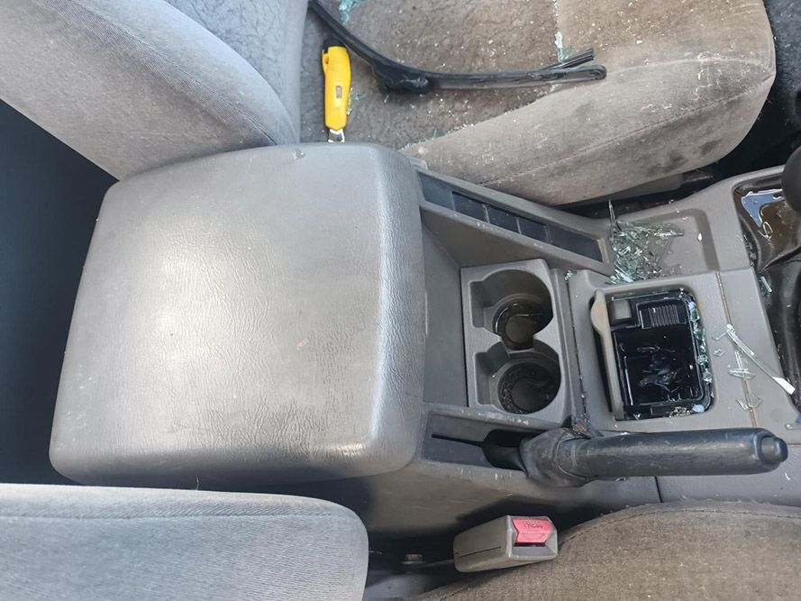 A Car Console with Two Cup Holders and a Screwdriver in It — South West 4WD Wreckers in Harristown, QLD