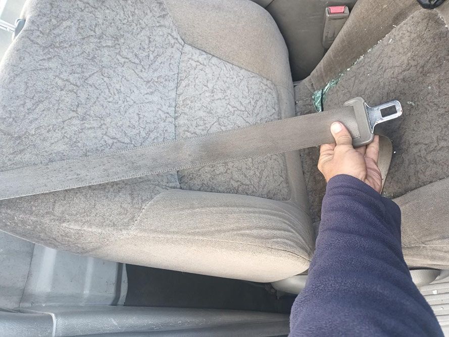 A Person is Holding a Seat Belt in a Car — South West 4WD Wreckers in Harristown, QLD