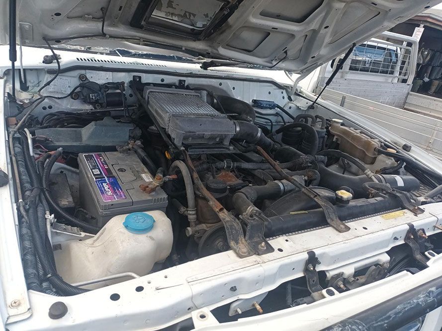 The Engine of a White Car is Shown with the Hood Open — South West 4WD Wreckers in Harristown, QLD