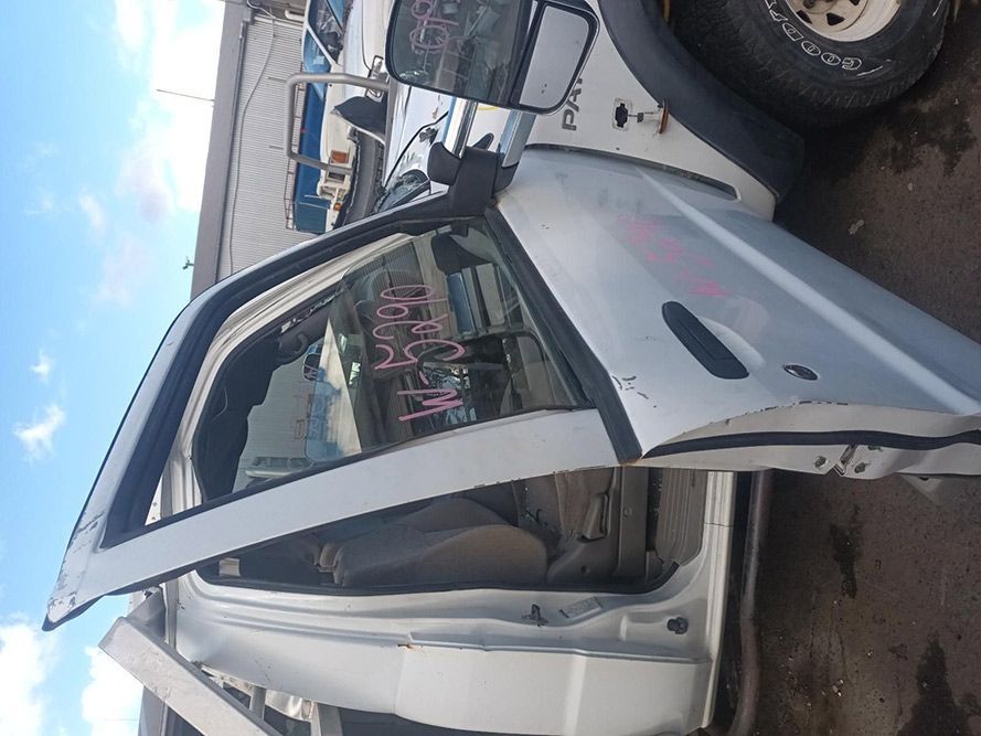 A White Truck with the Door Open is Sitting on the Ground — South West 4WD Wreckers in Harristown, QLD