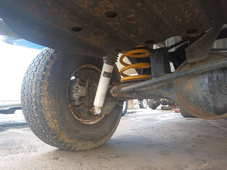 A Close Up of the Underside of a Car with a Tire and Shock Absorber — South West 4WD Wreckers in Harristown, QLD