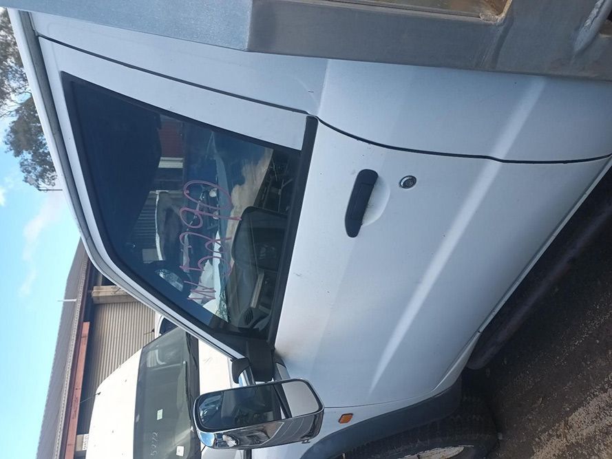 A White Truck with the Door Open is Parked in a Parking Lot — South West 4WD Wreckers in Harristown, QLD