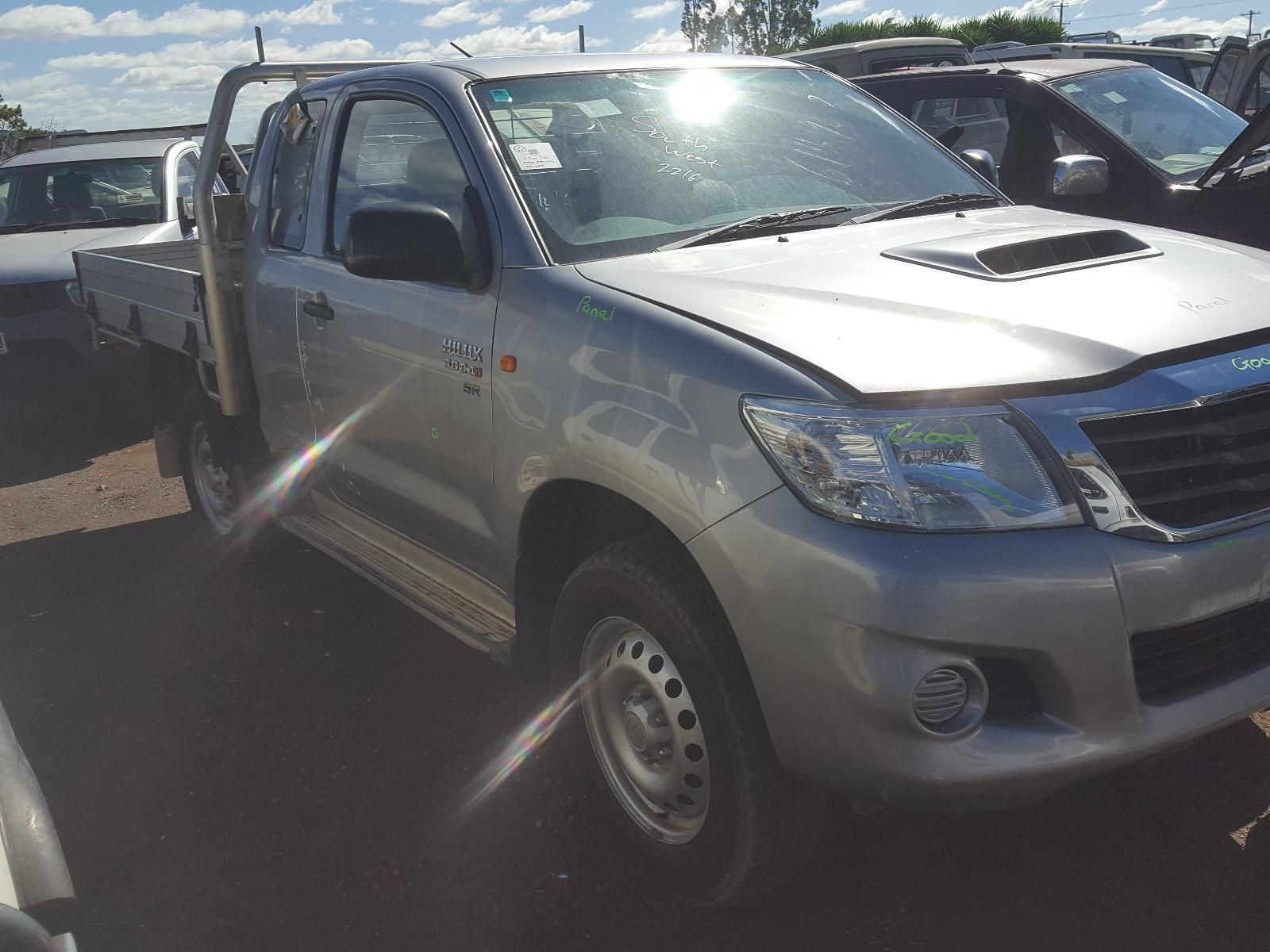 A Blue Isuzu Truck is Parked Next to a Silver Car — South West 4WD Wreckers In Brisbane, QLD