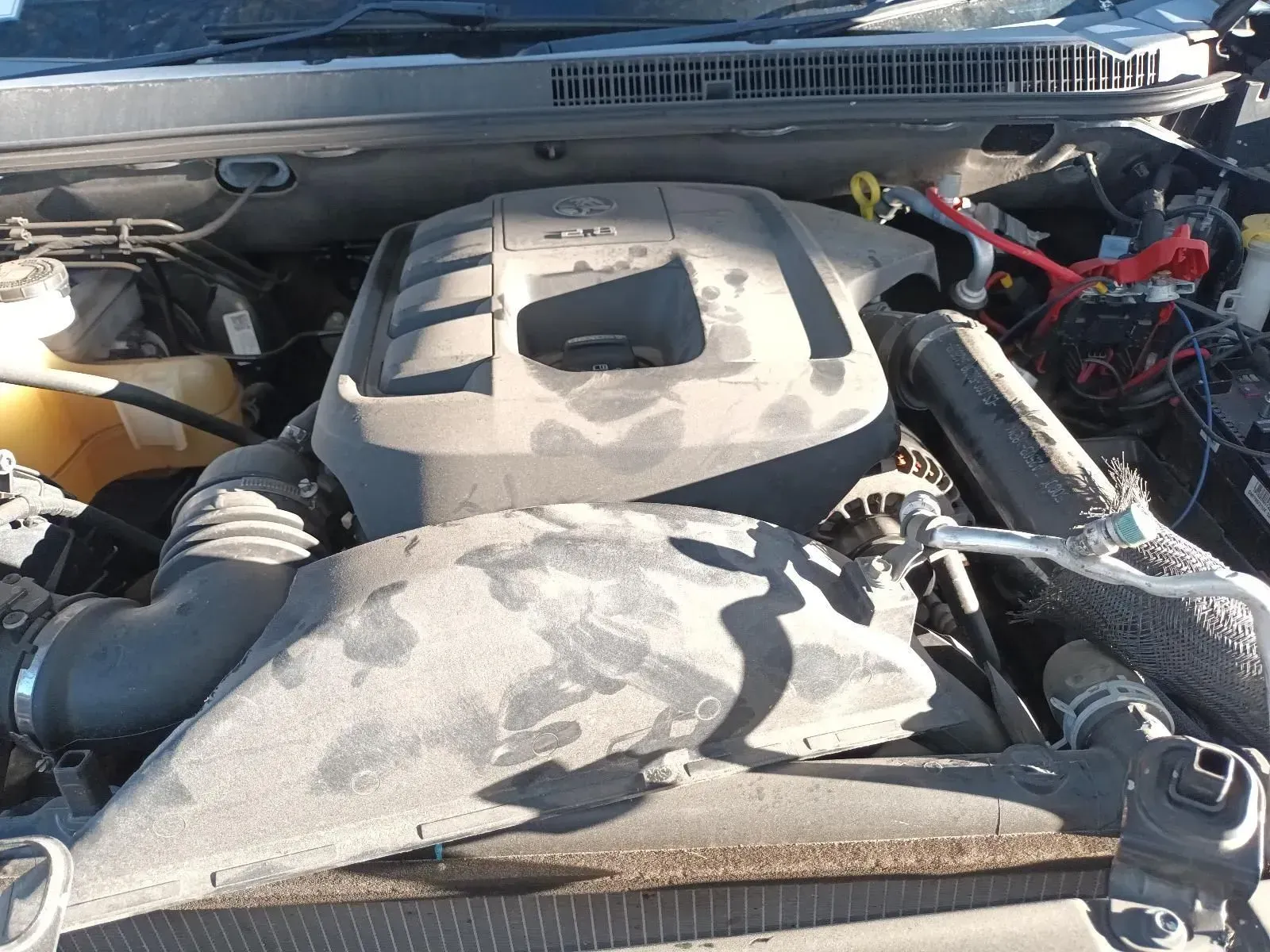 Engine of a Car, Dusty, Black and Gray. Hoses and Tubes Visible — South West 4WD Wreckers In Brisbane, QLD