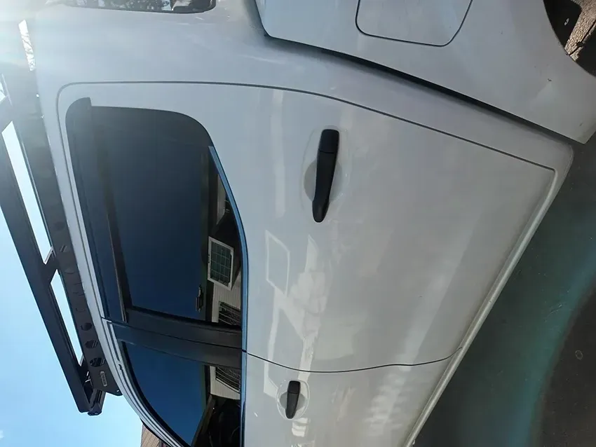 A White Van is Parked on the Side of the Road — South West 4WD Wreckers In Brisbane, QLD