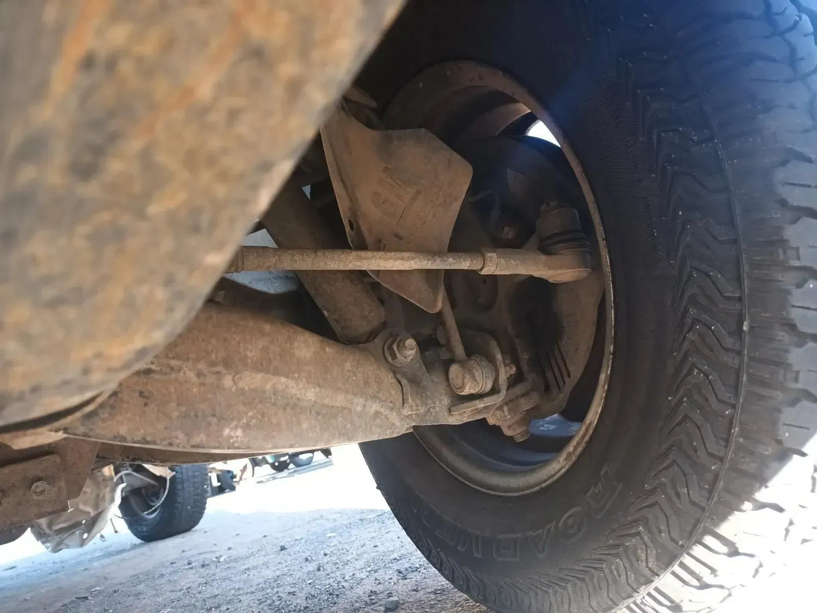 Rusty Vehicle Undercarriage With a Tyre and Suspension Components — South West 4WD Wreckers In Brisbane, QLD