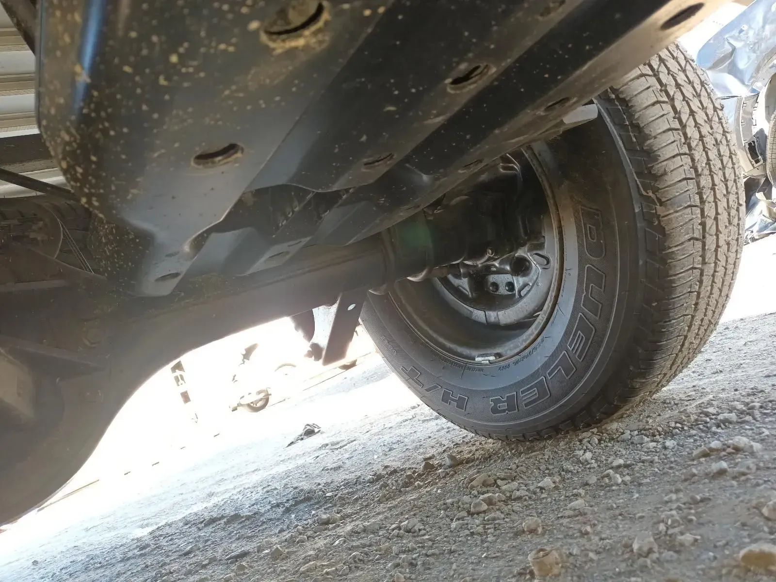 Underside of Black Vehicle Chassis With a Tyre Visible — South West 4WD Wreckers In Brisbane, QLD