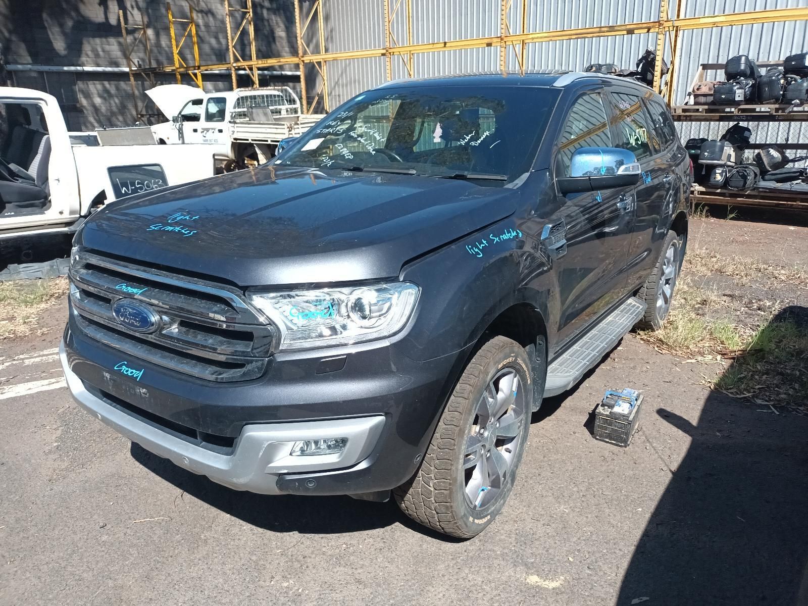 A Black Truck With a White Bed is Parked on the Side of the Road — South West 4WD Wreckers In Brisbane, QLD
