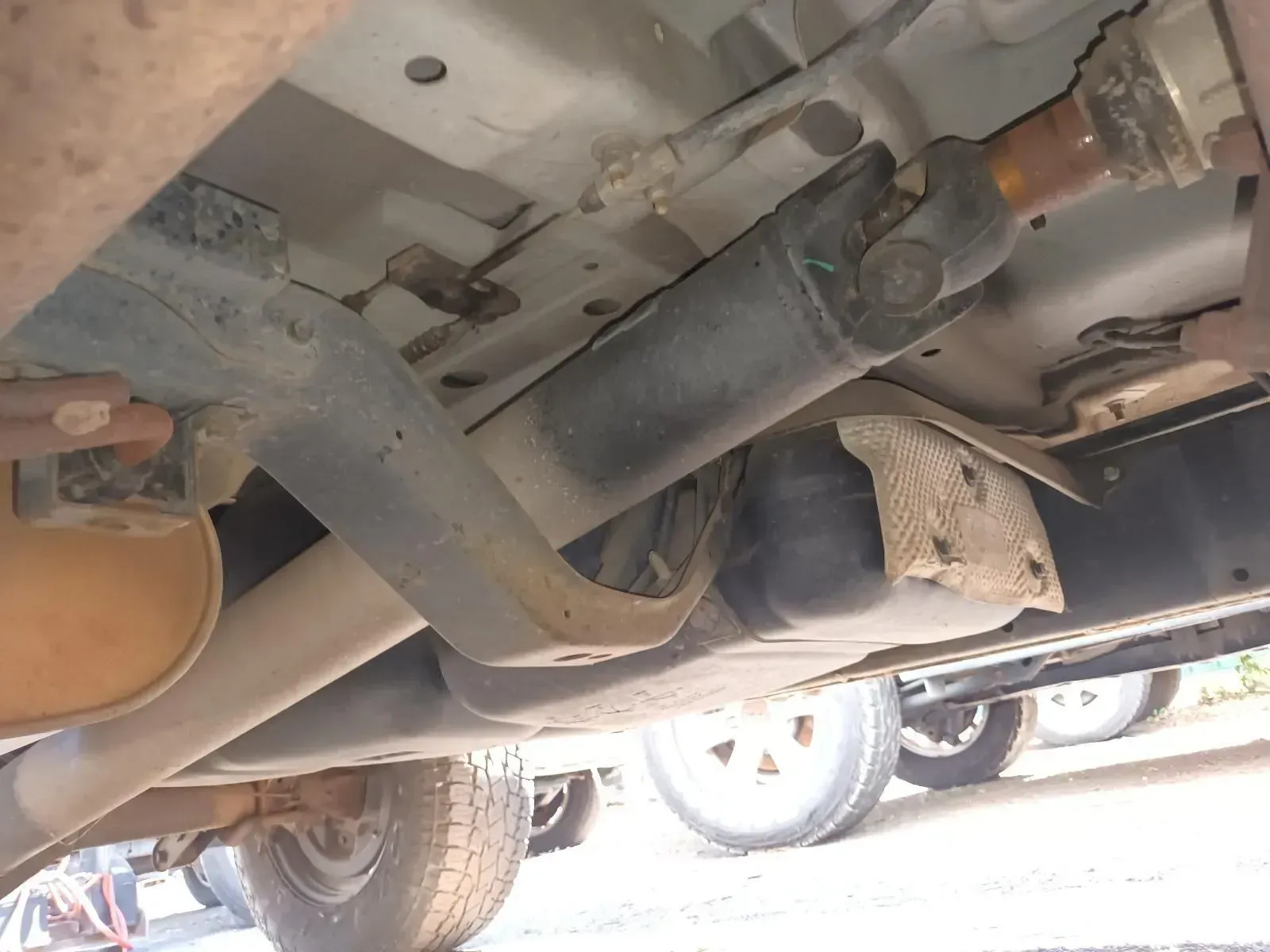 Underside View of a Vehicle Showing a Driveshaft, Exhaust, Frame, and Tyres — South West 4WD Wreckers In Brisbane, QLD