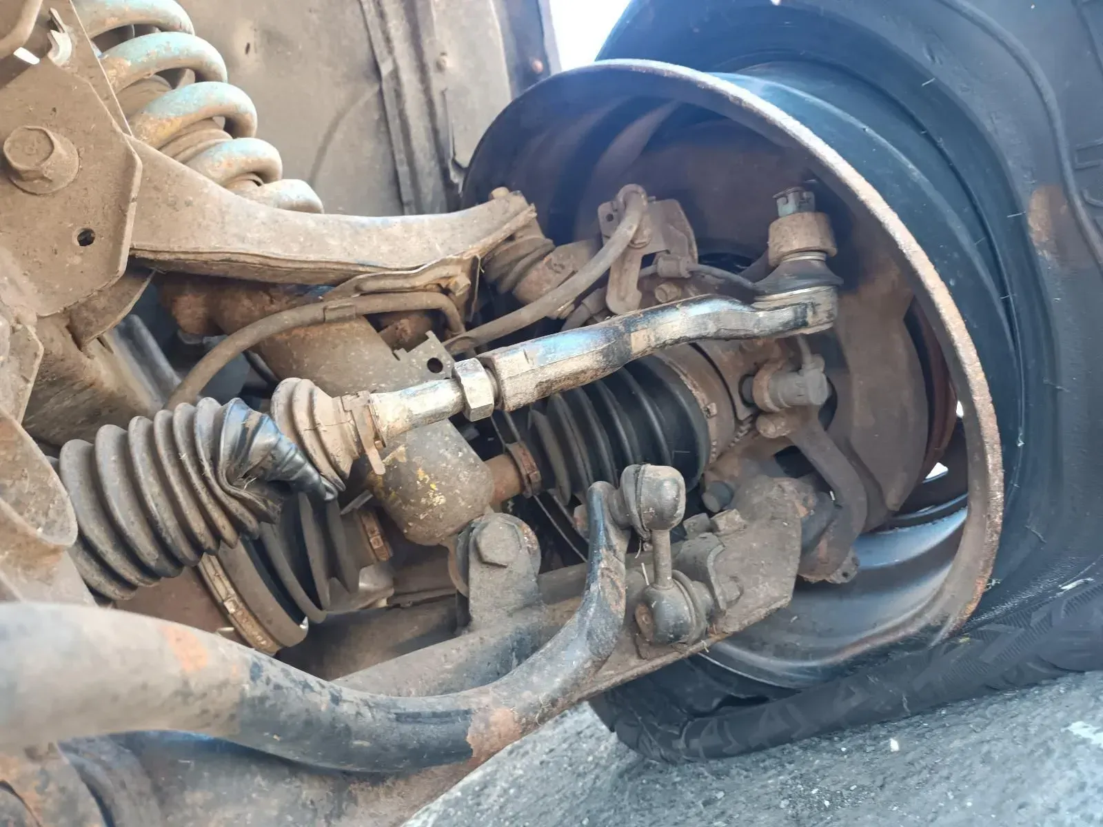 Front Suspension of a Vehicle With a Detached Wheel, Showing Various Components — South West 4WD Wreckers In Brisbane, QLD