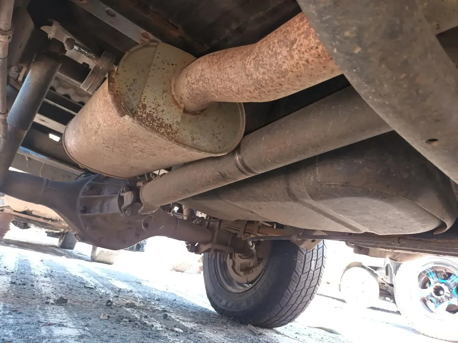Undercarriage of a Truck With Exhaust System, Fuel Tank, and Rear Tyre Visible — South West 4WD Wreckers In Brisbane, QLD