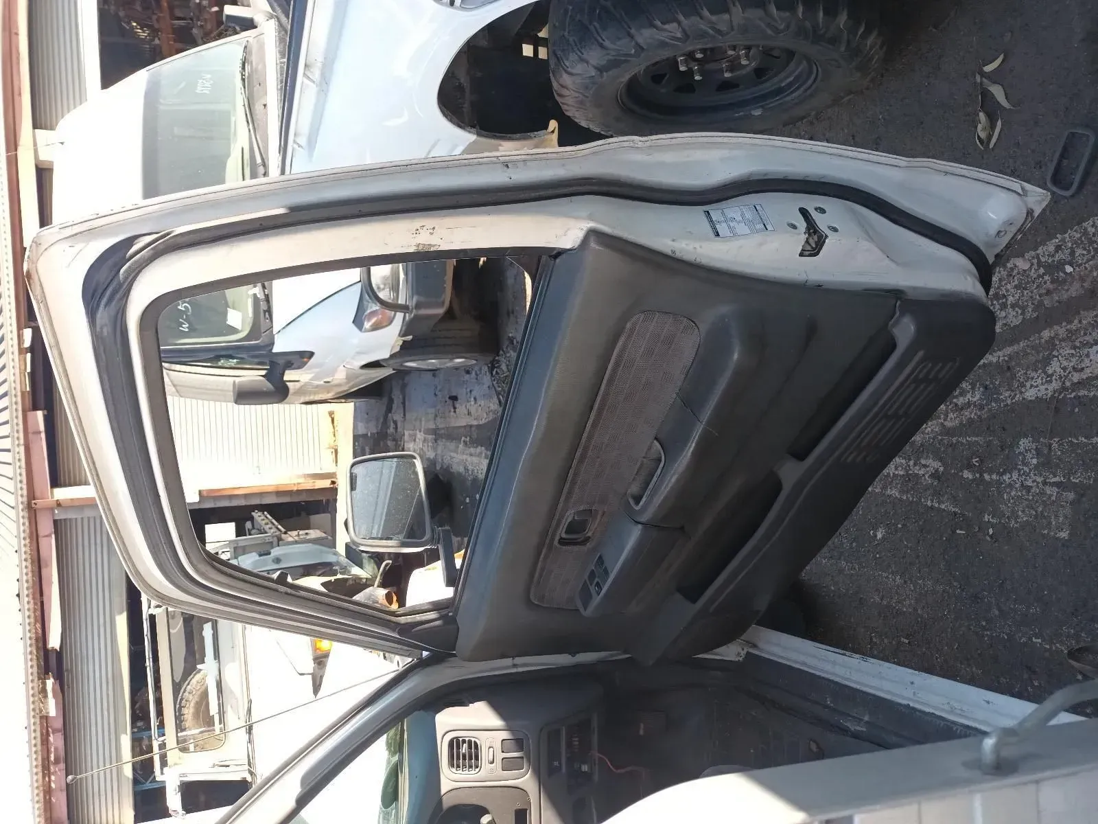 a Gray Car Door, Open, Showing the Interior Panel and Part of the Vehicle's Cabin — South West 4WD Wreckers In Brisbane, QLD