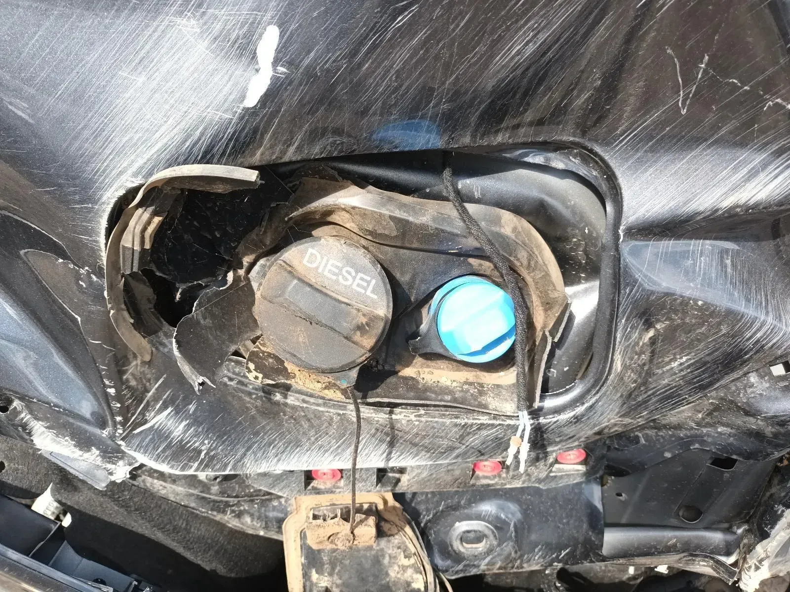Damaged Car Fuel Door With Black Diesel Cap and Blue AdBlue Cap — South West 4WD Wreckers In Brisbane, QLD