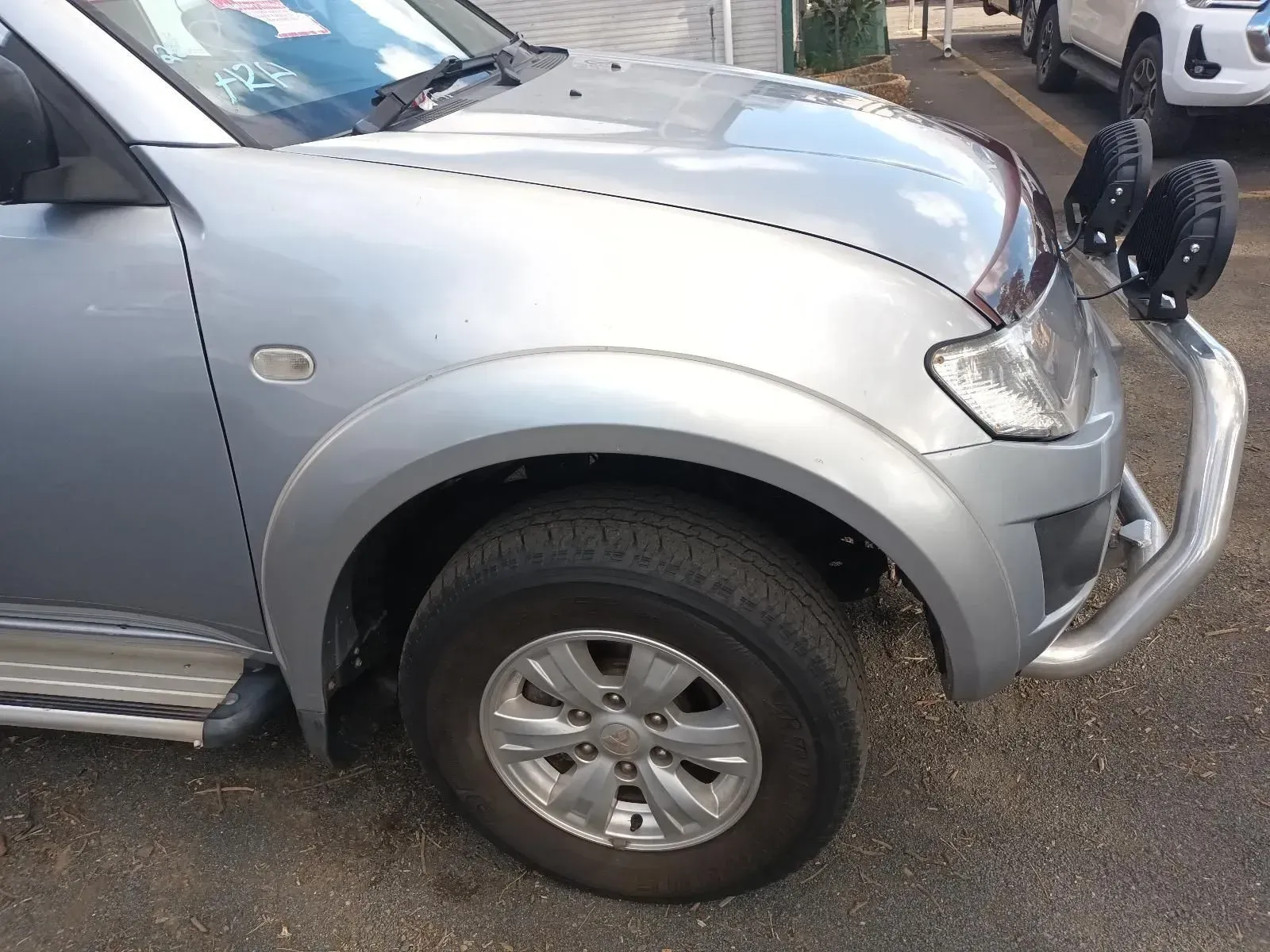 Silver Pickup Truck Front With a Tyre, Bumper, and Light Attachments — South West 4WD Wreckers In Brisbane, QLD