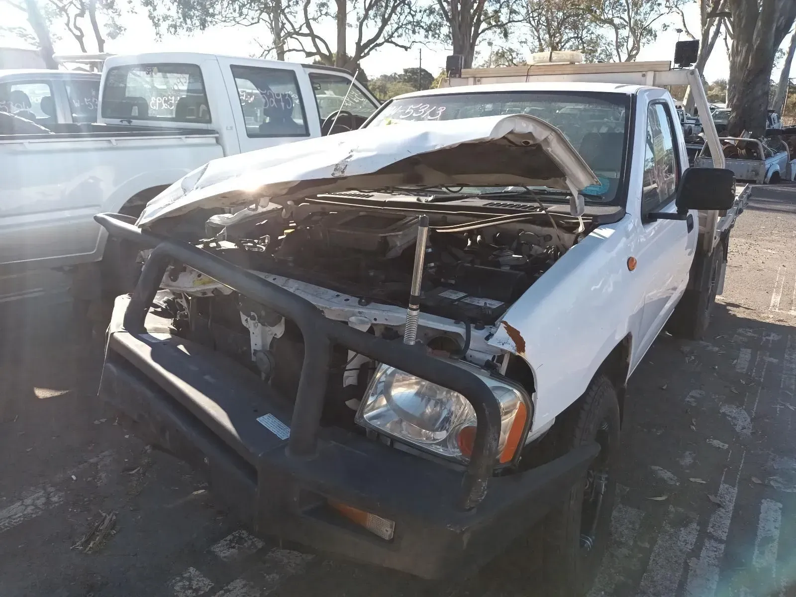 White Pickup Truck With Extensive Front-end Damage and a Bull Bar — South West 4WD Wreckers In Brisbane, QLD