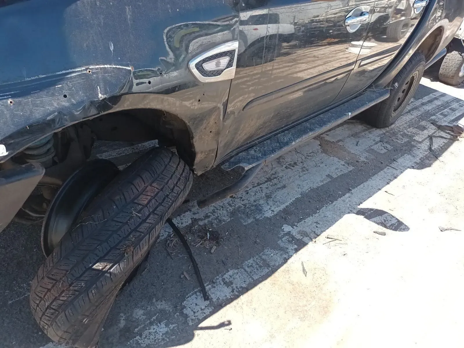 Black Car With a Missing Tyre, Showing Damage to the Side Panel — South West 4WD Wreckers In Brisbane, QLD