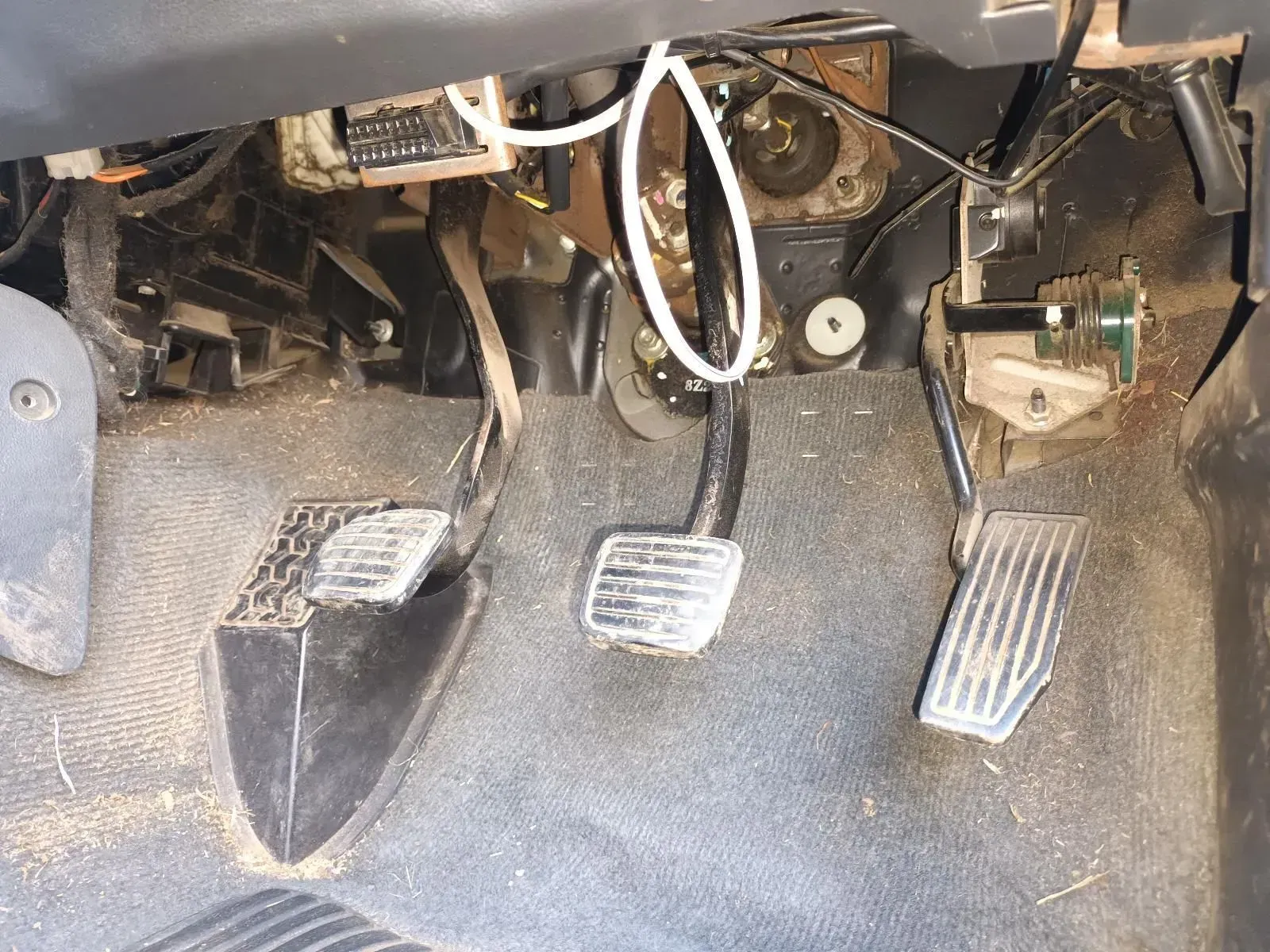 Foot Pedals Inside a Car, Showing Wires and Mechanical Components — South West 4WD Wreckers In Brisbane, QLD