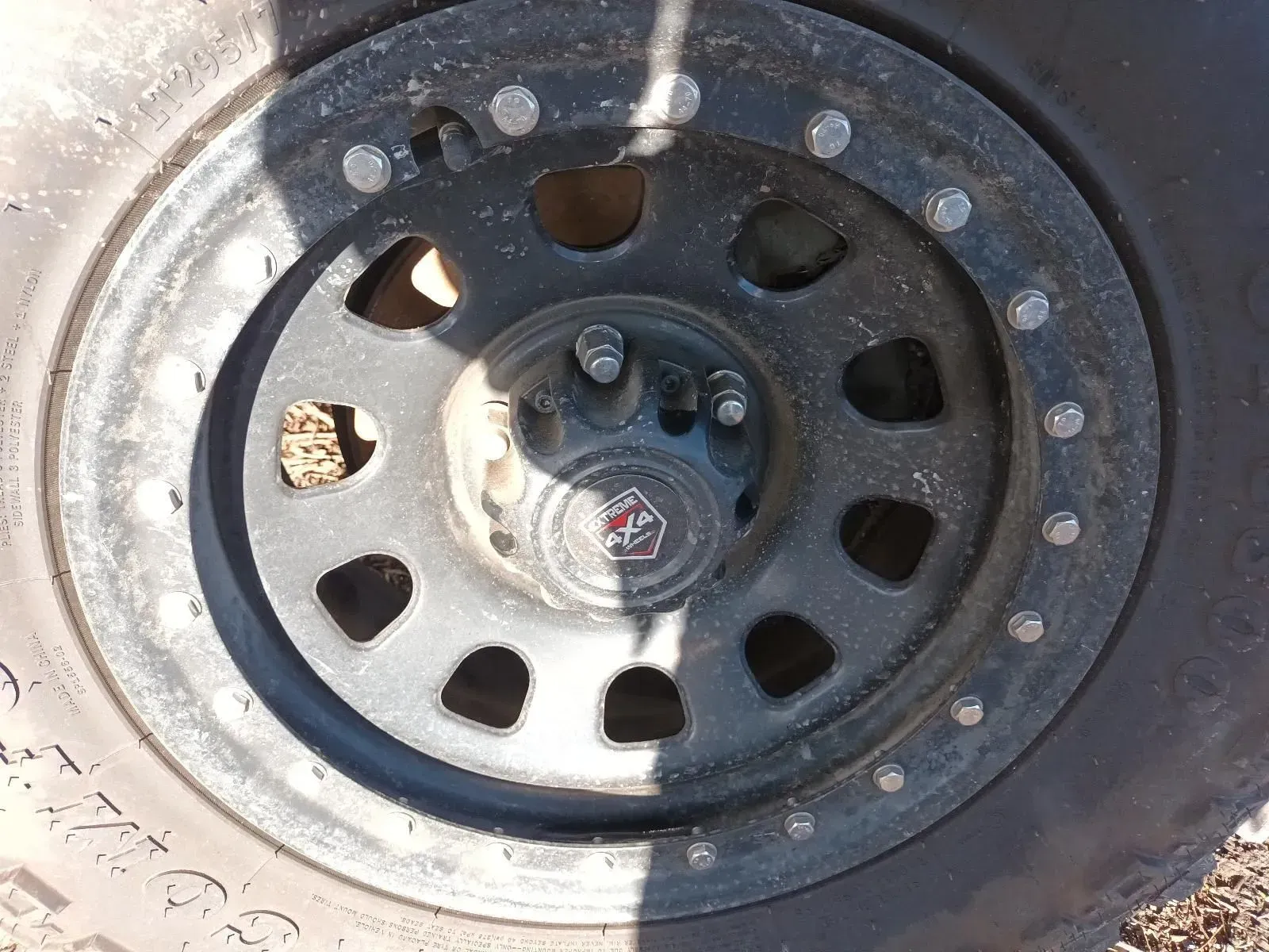 Black Off-road Wheel With a Circular Pattern of Holes and Bolts — South West 4WD Wreckers In Brisbane, QLD