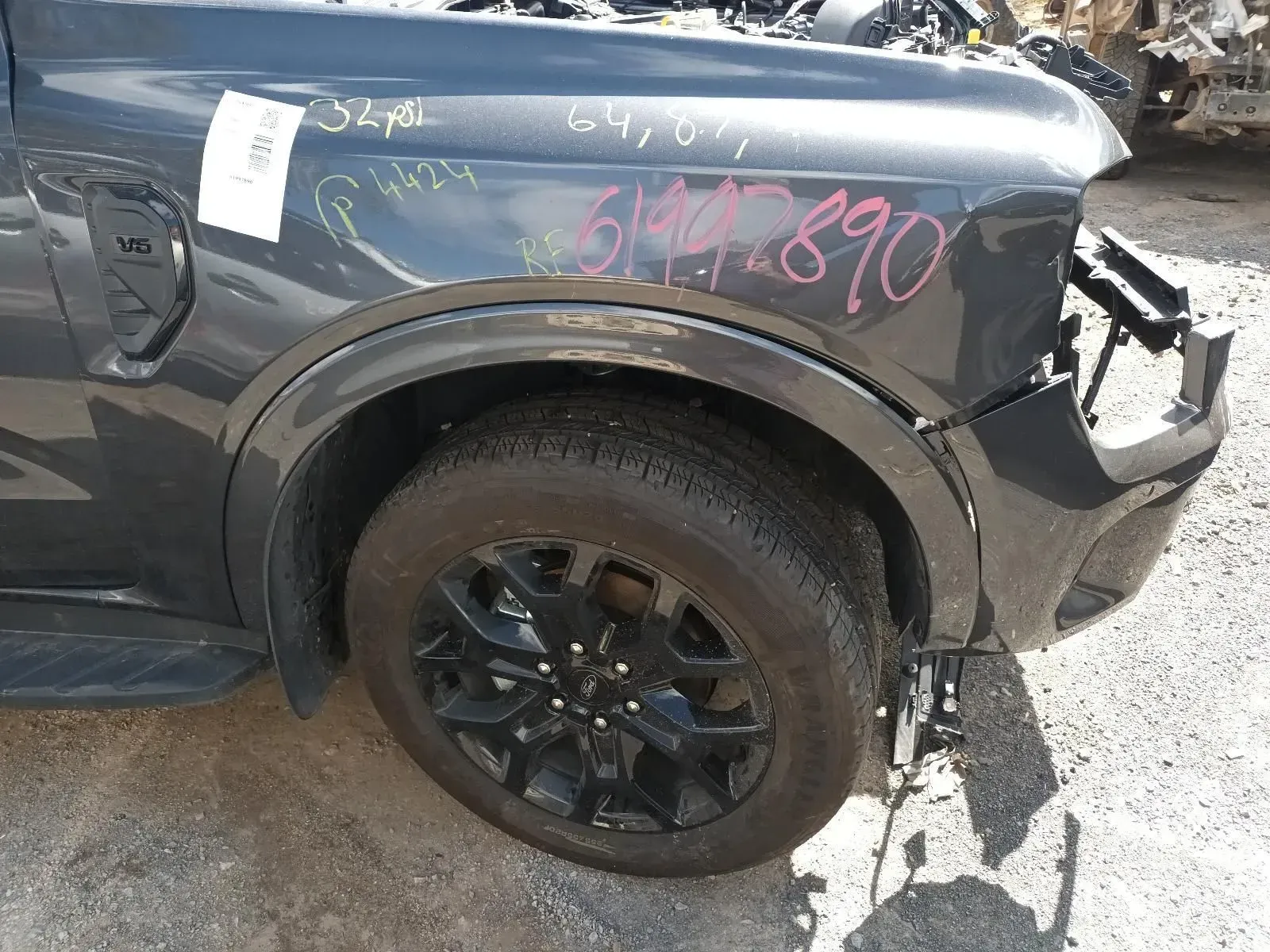 Gray Car Fender With Black Wheel and Tyre; a Salvage Yard — South West 4WD Wreckers In Brisbane, QLD