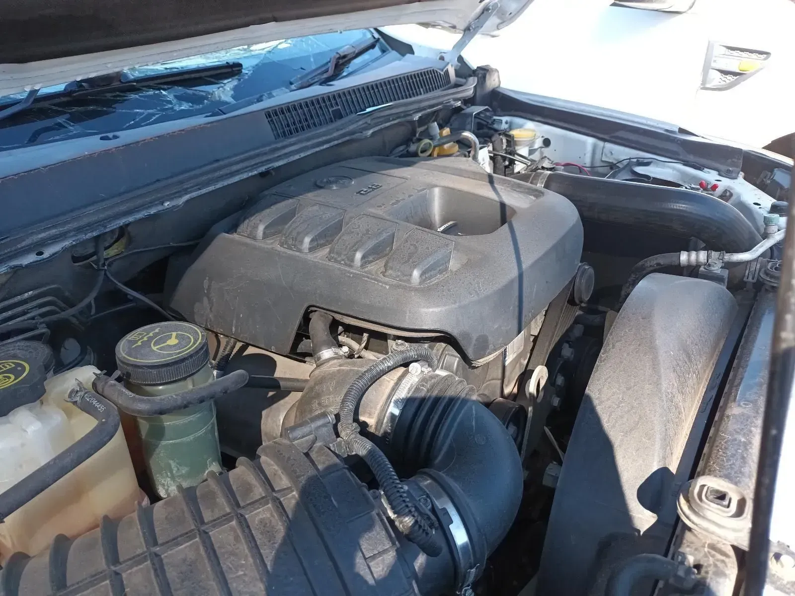 Engine Compartment of a Car With Black Plastic Covers and Air Intake. Dusty — South West 4WD Wreckers In Brisbane, QLD