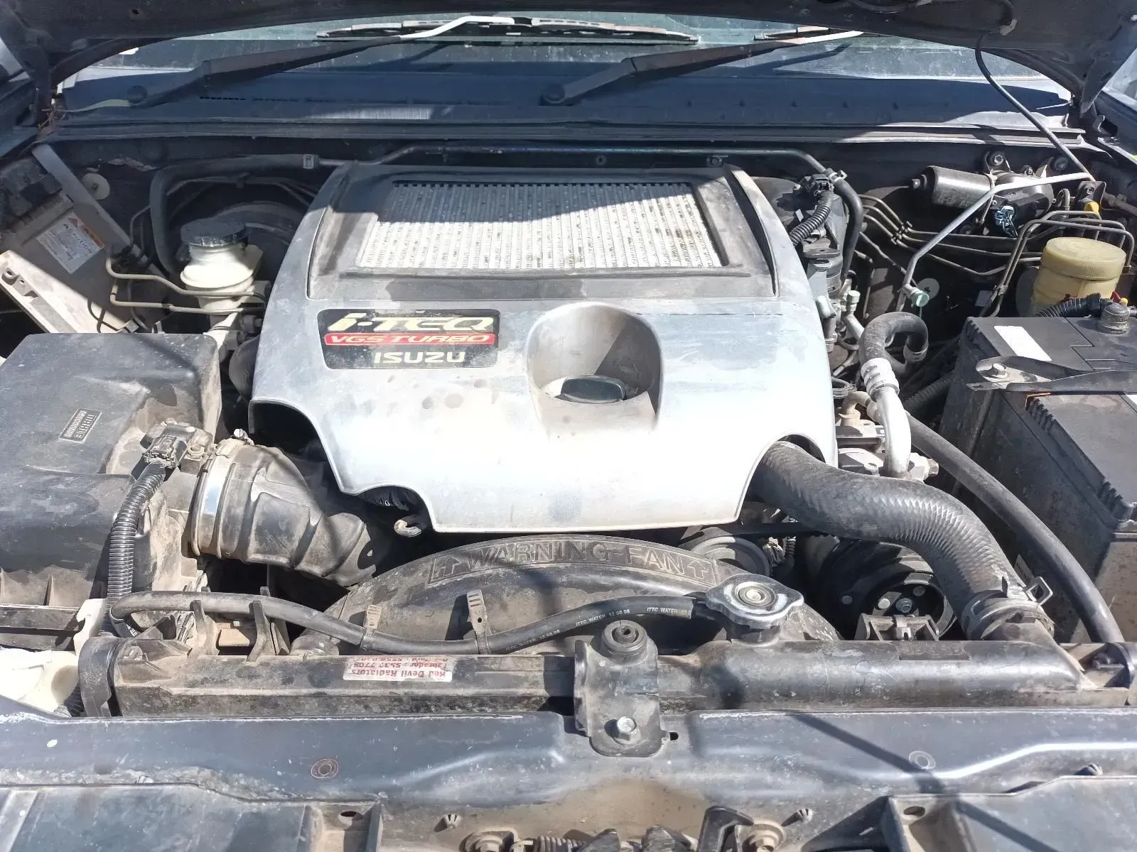 Isuzu Engine Under the Hood of a Vehicle, Featuring a Metal Cover — South West 4WD Wreckers In Brisbane, QLD