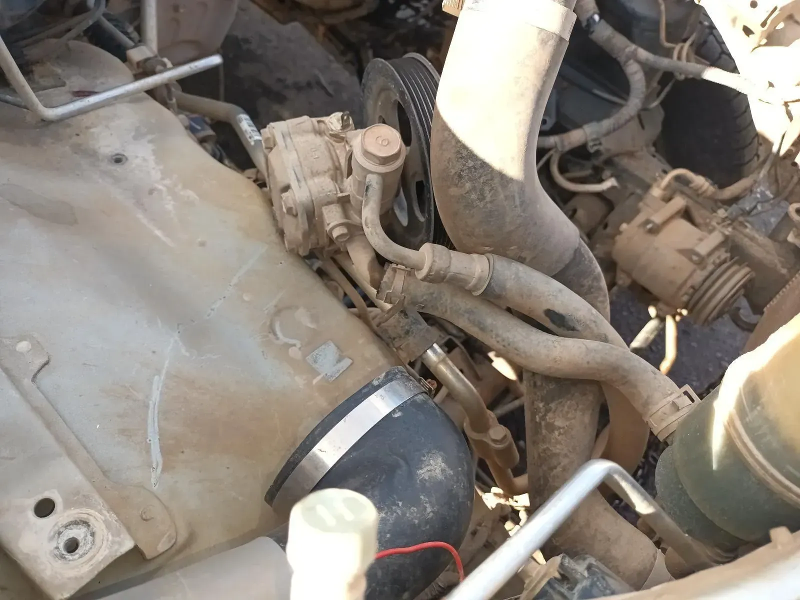 Engine Bay, Dirty. Power Steering Pump, Hoses, Belts, and Coolant Hoses Visible — South West 4WD Wreckers In Brisbane, QLD