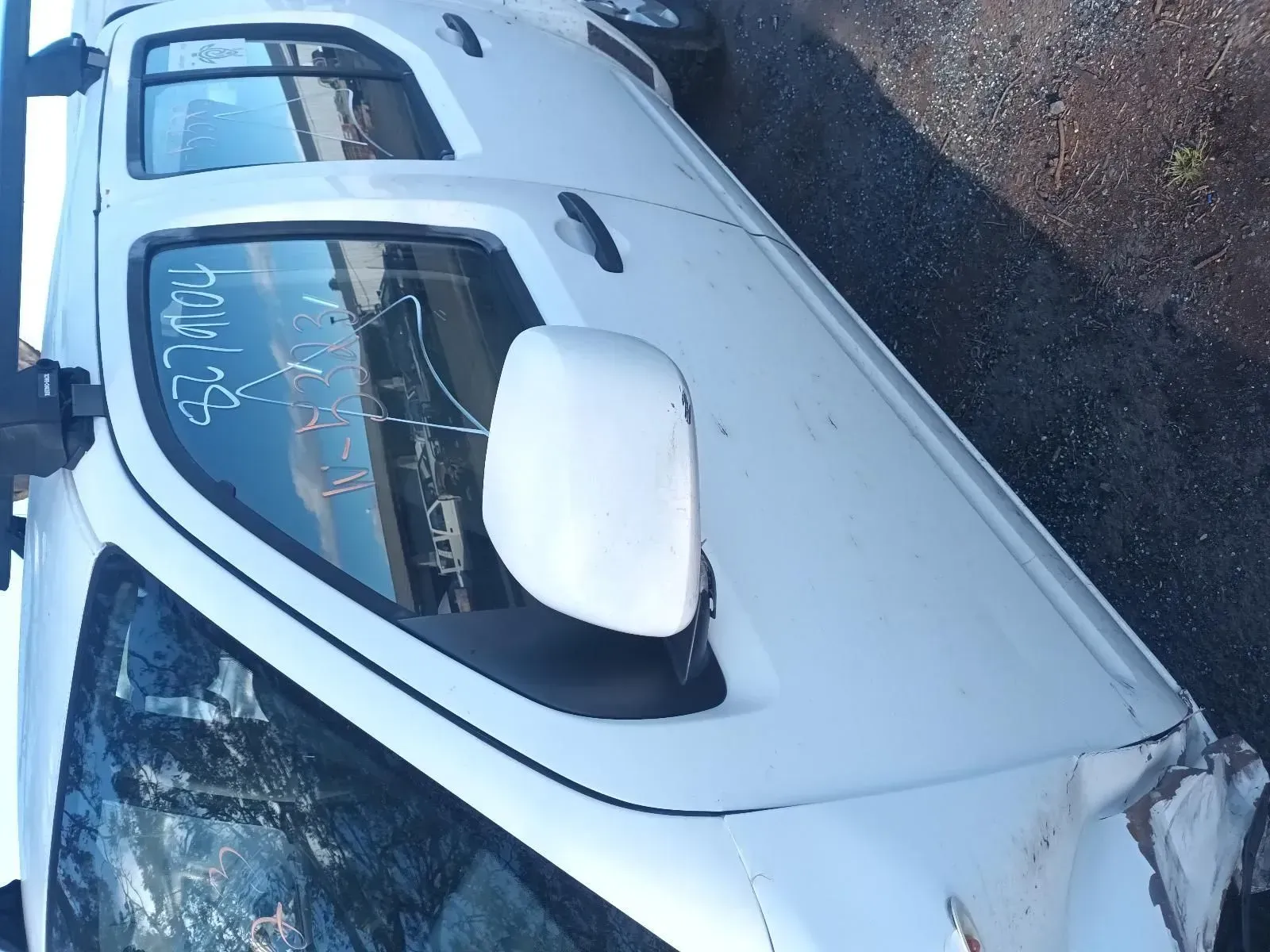 White Car, Damaged Front, Side Mirror Visible — South West 4WD Wreckers In Brisbane, QLD