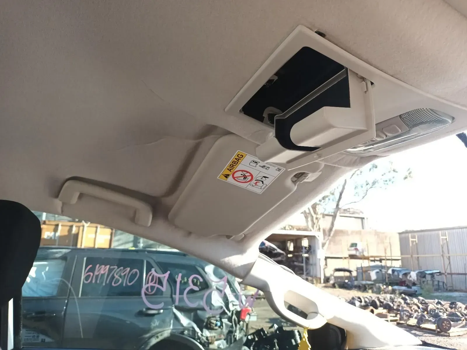 Tan Car Interior With Sun Visor, Overhead Console, and Damaged Vehicle — South West 4WD Wreckers In Brisbane, QLD