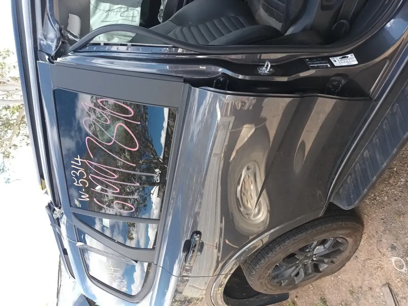 Dark Gray Suv Door and Rear Wheel. Door Has Writing on the Window — South West 4WD Wreckers In Brisbane, QLD