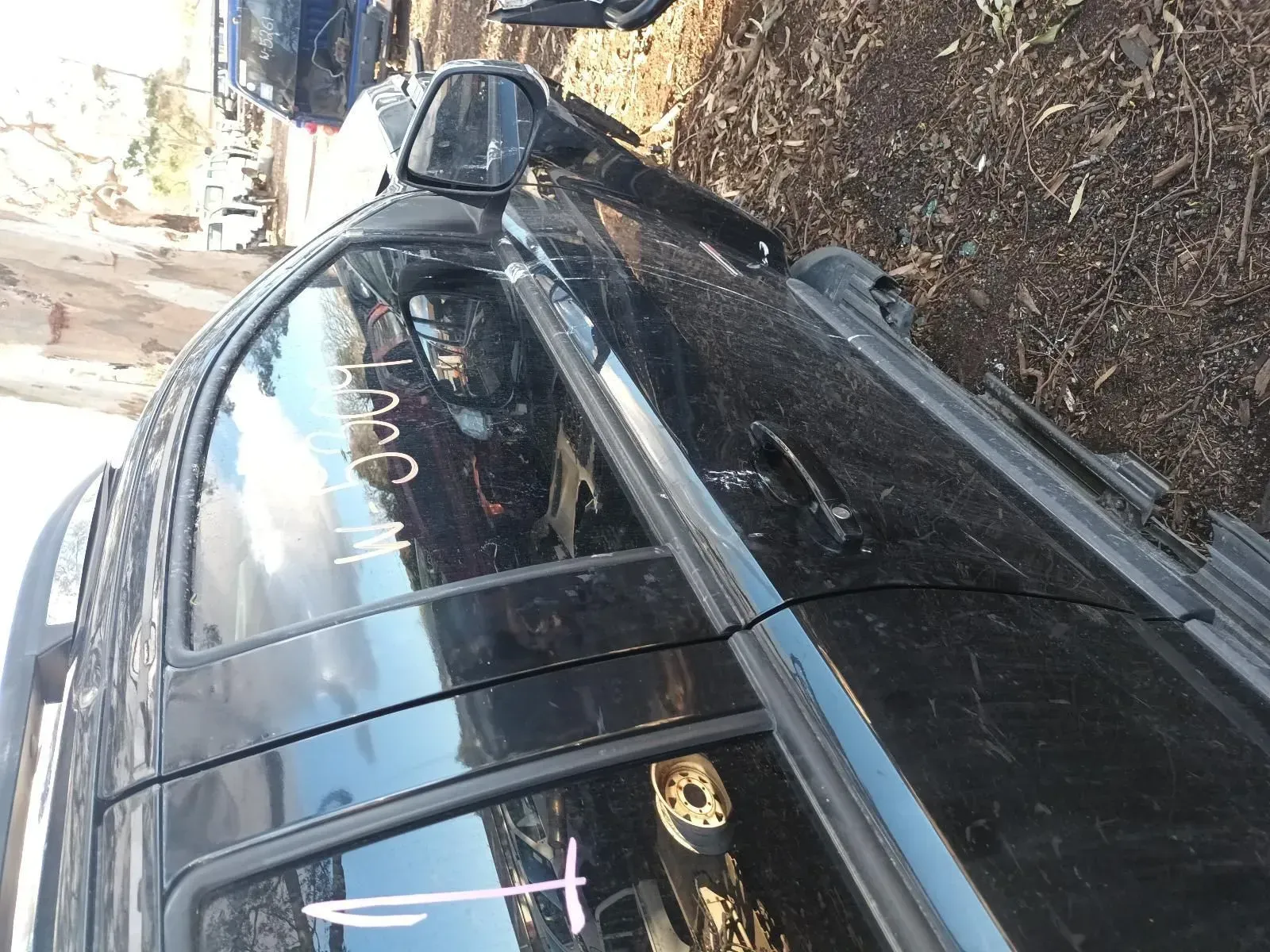 Black Vehicle Door With Window. Exterior Shot at a Junkyard — South West 4WD Wreckers In Brisbane, QLD