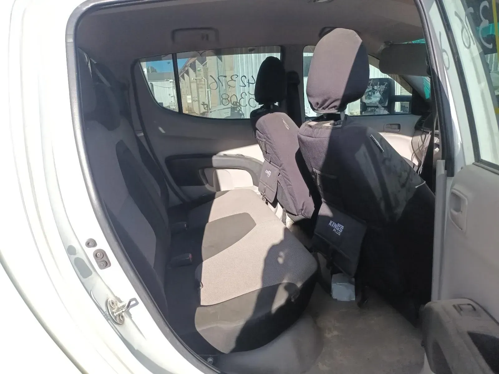 Interior of a White Pickup Truck Showing Back Seats, With Headrests and Door Ajar — South West 4WD Wreckers In Brisbane, QLD