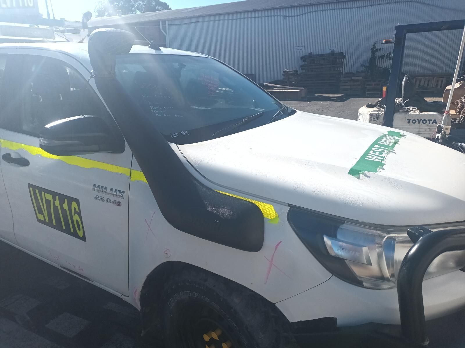A White Truck with a Snorkel on the Hood is Parked in a Parking Lot — South West 4WD Wreckers in Harristown, QLD 