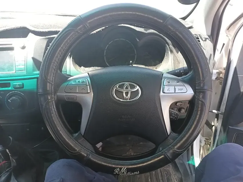 A Person is Sitting in a Car With a Steering Wheel Cover on It — South West 4WD Wreckers In Brisbane, QLD