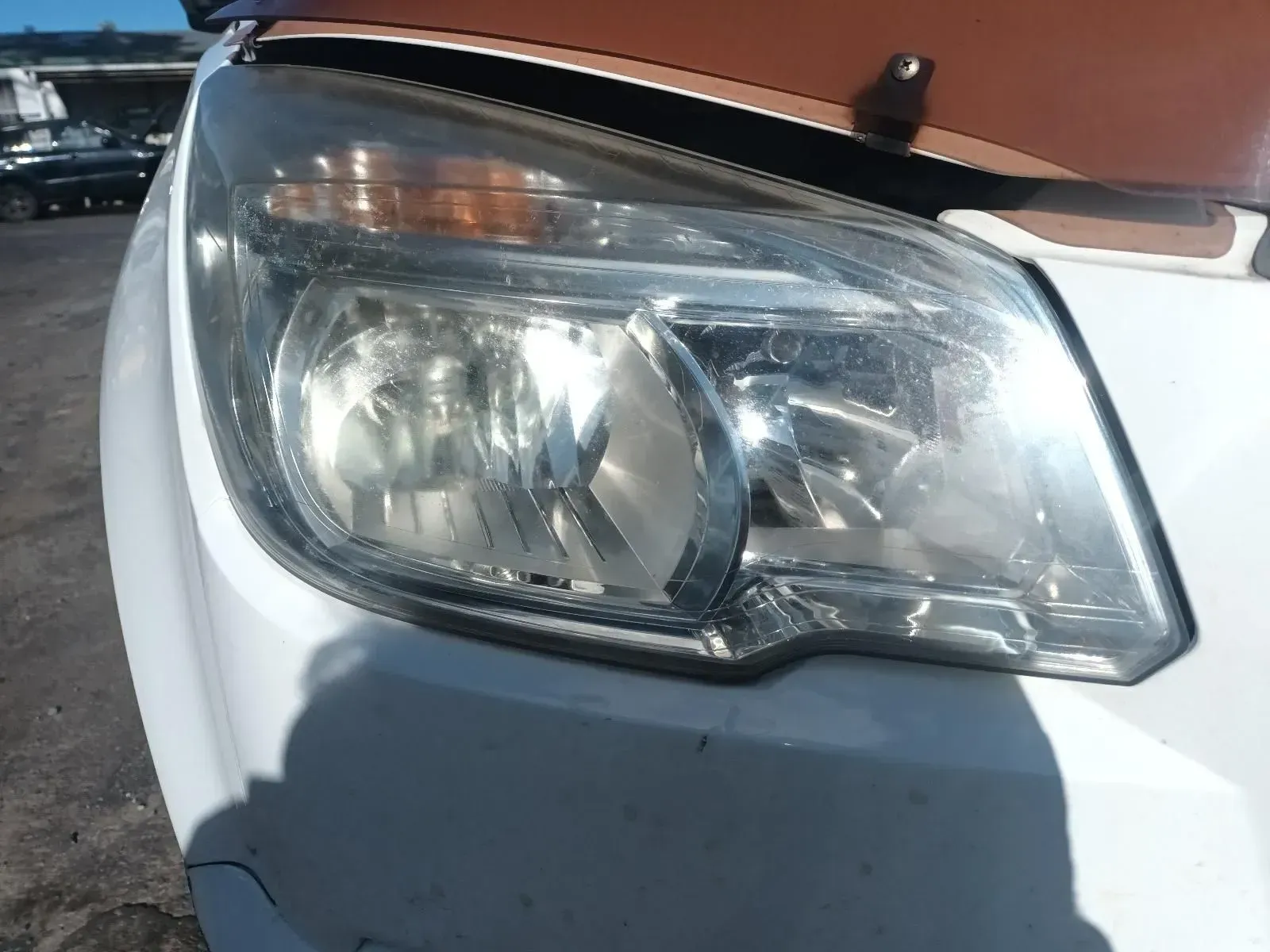 Close-up of a White Car's Headlight — South West 4WD Wreckers In Brisbane, QLD