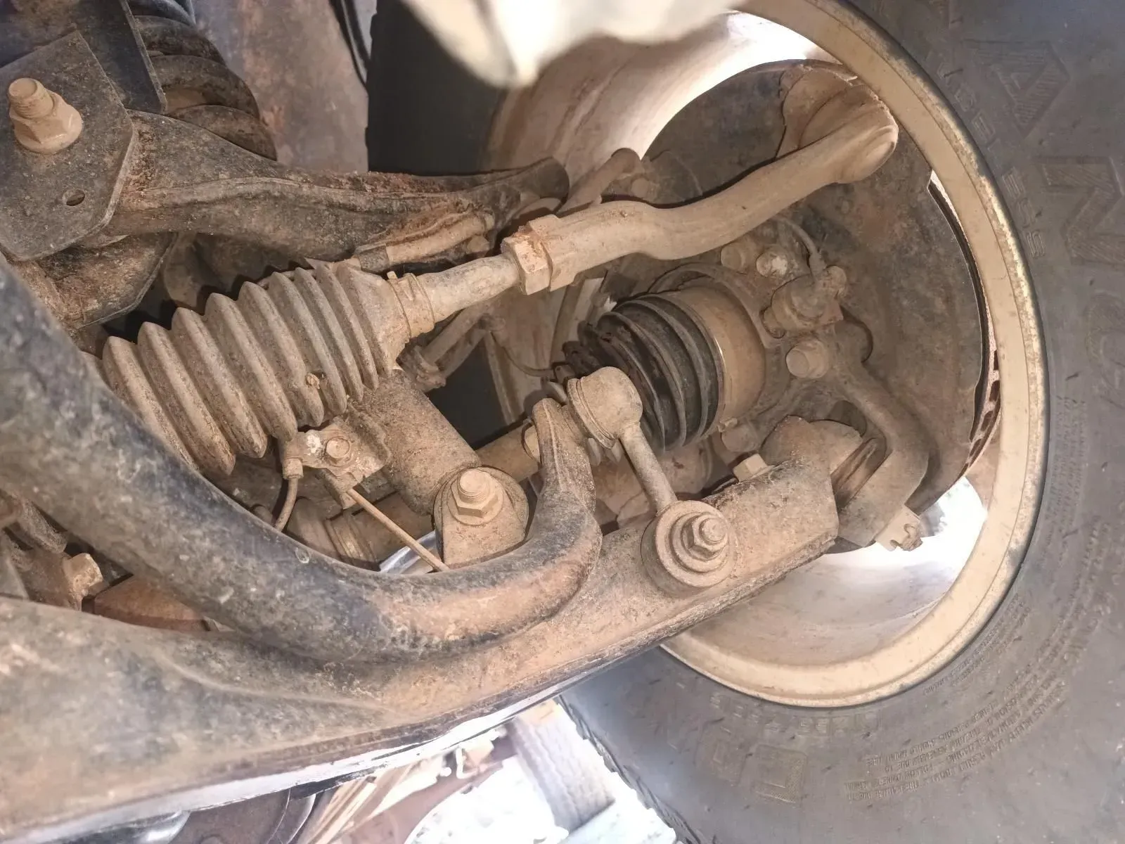 Underside of a Car's Front Suspension. Dusty Metal Components — South West 4WD Wreckers In Brisbane, QLD