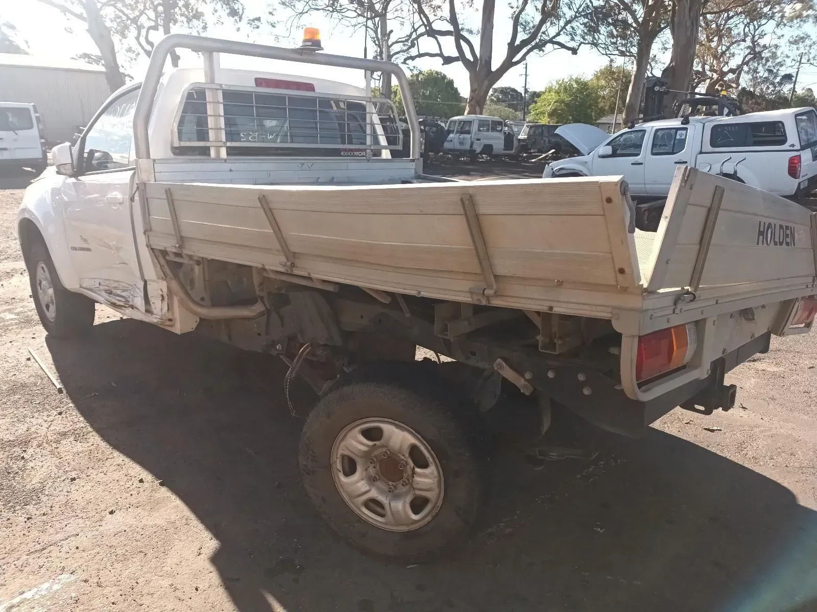 White Flatbed Pickup Truck, Outdoors on a Sunny Day, Possibly a Junkyard — South West 4WD Wreckers In Brisbane, QLD