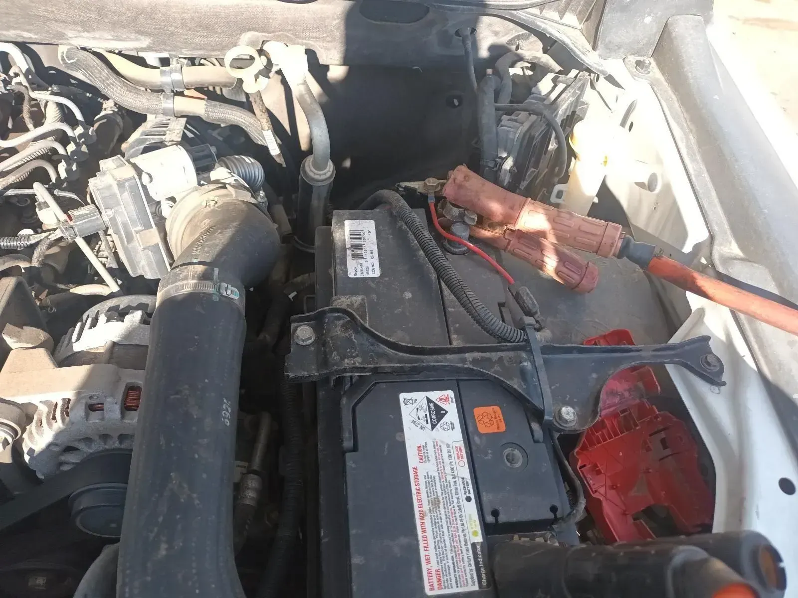 Car Battery With Jumper Cables Connected in an Engine Bay — South West 4WD Wreckers In Brisbane, QLD