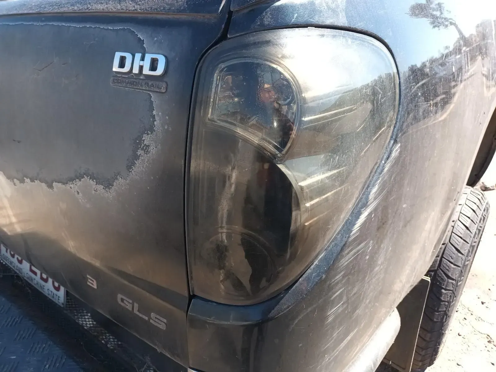 Black Pickup Truck's Rear, Showing a Tinted Taillight, Peeling Paint — South West 4WD Wreckers In Brisbane, QLD