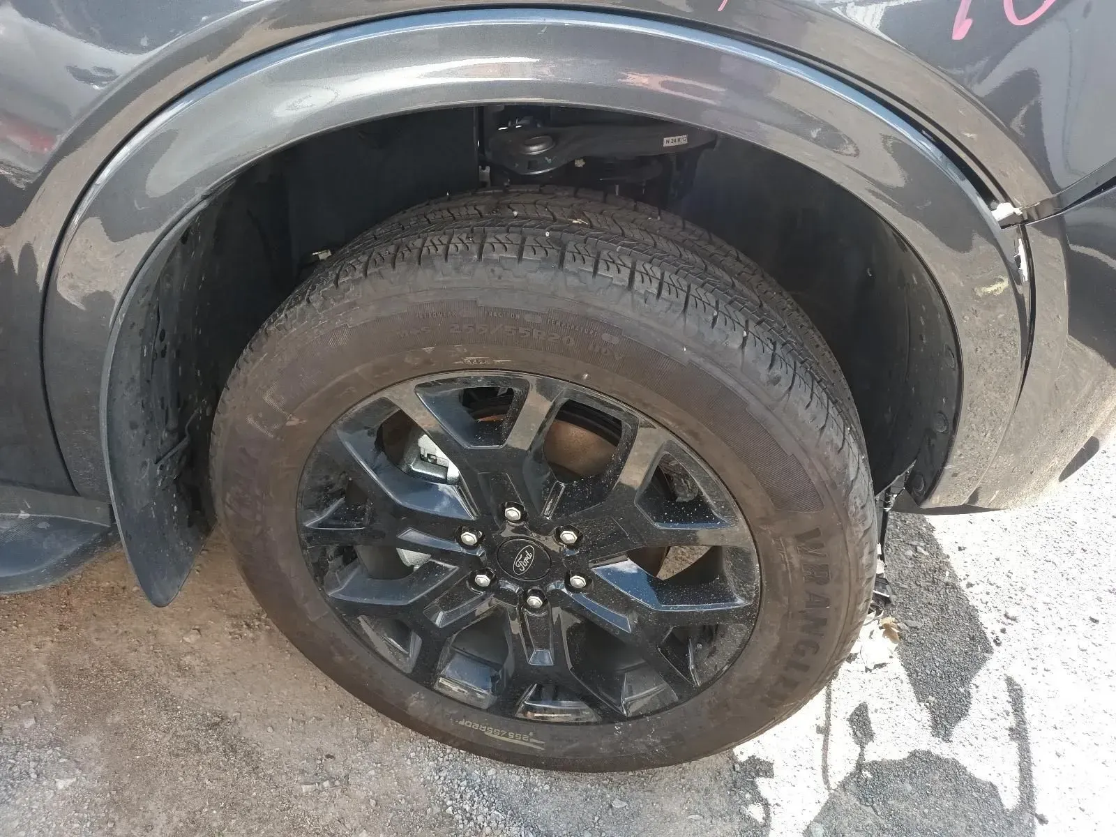 Black Car Wheel and Tyre in a Wheel Well — South West 4WD Wreckers In Brisbane, QLD