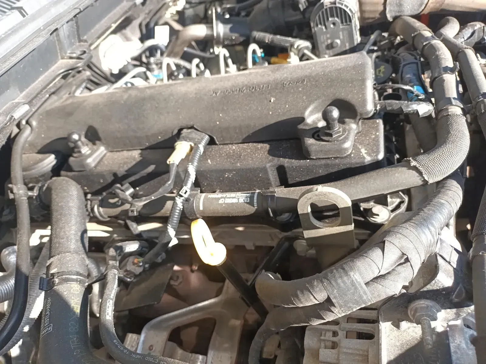 Car Engine Compartment, Black Engine Cover, and Various Hoses and Wires — South West 4WD Wreckers In Brisbane, QLD